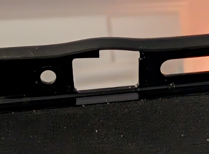 A picture of the bottom of a phone case showing a portion of the plastic missing causing deformation.